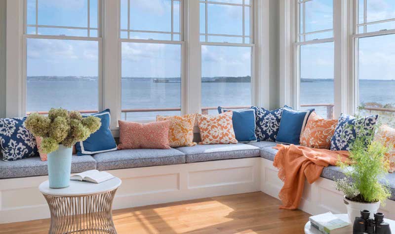 RHB Assets From IGX: Sun-filled sunroom featuring a cozy afternoon nap nook with cushions and throws.