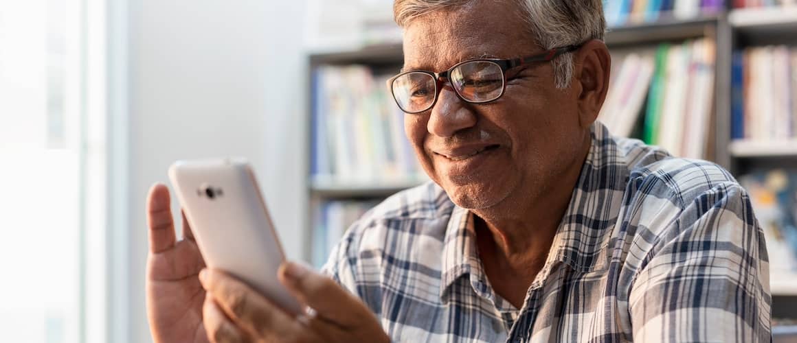 Older man using his smartphone.