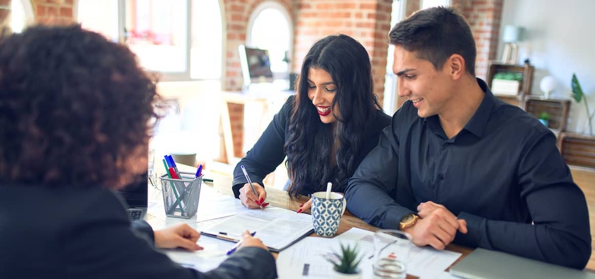 Couple discussing a CMT loan or adjustable-rate mortgage with a financial advisor.