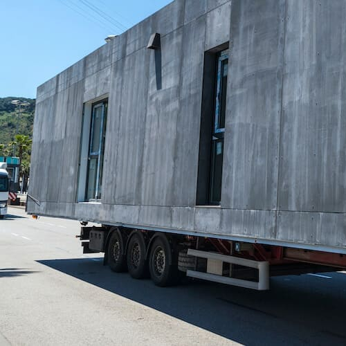 A modular home on a semi-truck, showcasing the transportation of a modular house.