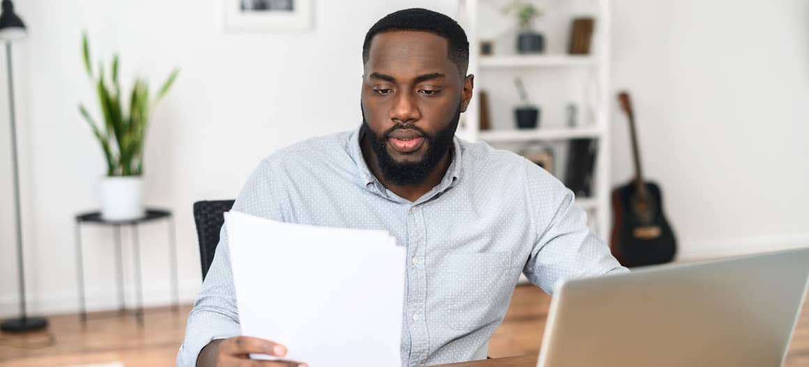 A man looking at a contract or document, potentially in a business or legal context.