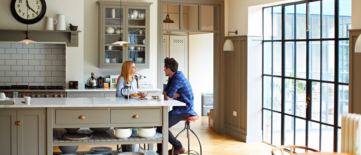 Stock-Couple-Sitting-In-Kitchen-compressor.jpeg