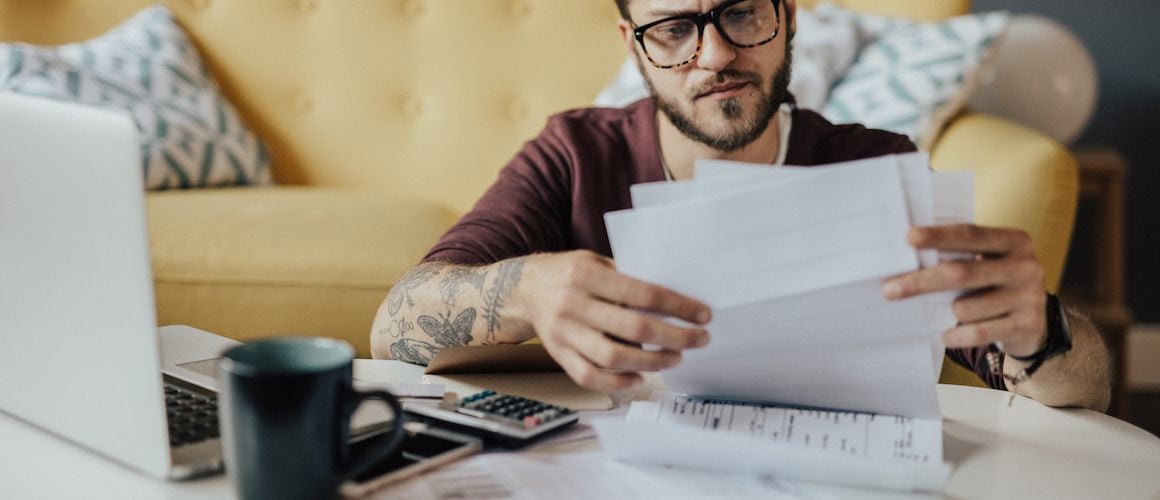 A man looking at finances, possibly related to financial planning or reviewing financial data.