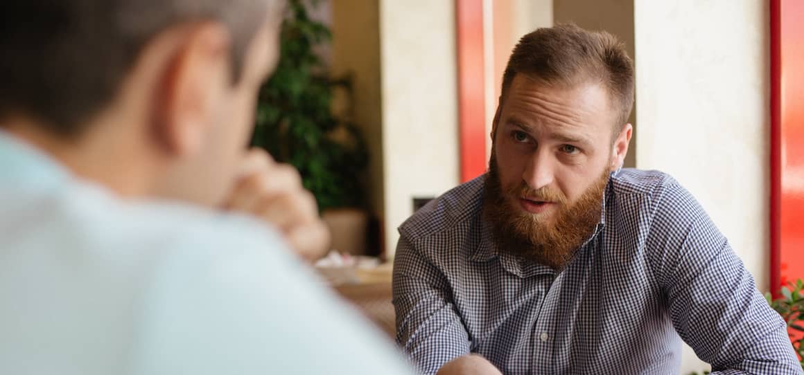 Two men having a serious conversation.