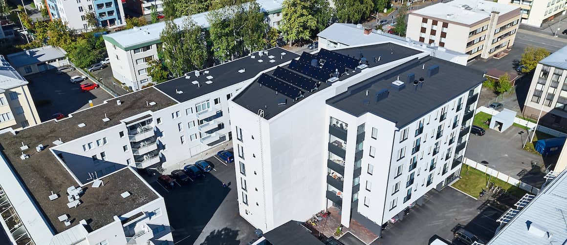 Aerial view of apartment building with solar panels.