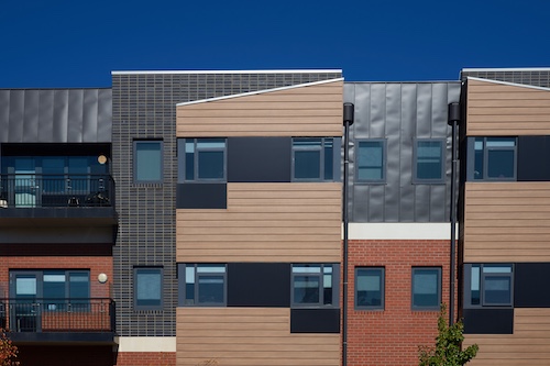 Modern apartment building with abstract style facade and in earth tones.