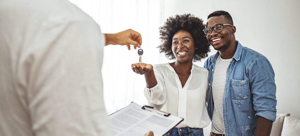 RHB Assets From IGX: A couple getting keys to their new home from a real estate agent.