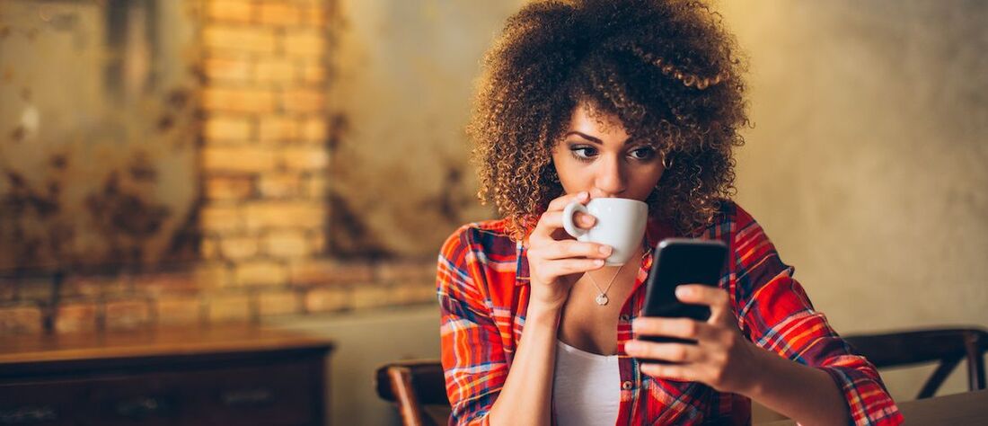 Stock-Woman-Drinking-Coffee-And-Using-Cellphone-Adobe-Stock-111942235-copy-compressor.jpeg