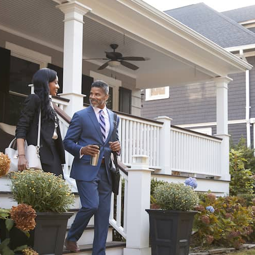 A couple leaving their house probably leaving for their jobs.