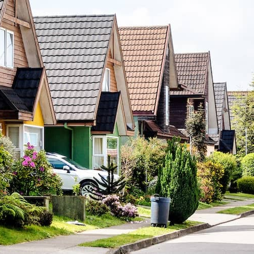 An image of a traditional neighborhood setting, depicting houses in a residential area.