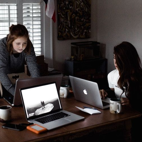 Image of women planning out emergency fund at kitchen table.