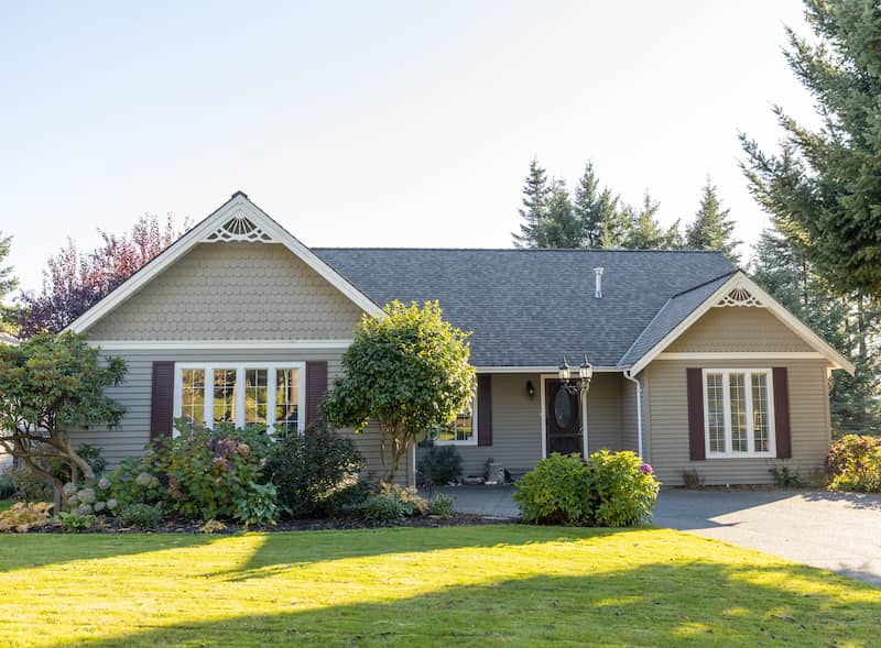 Exterior of single family home in suburban neighborhood on a sunny day.