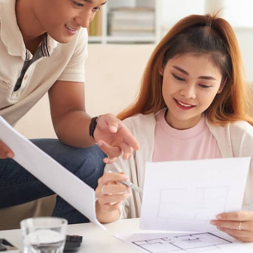 Young couple going over home improvement plans.