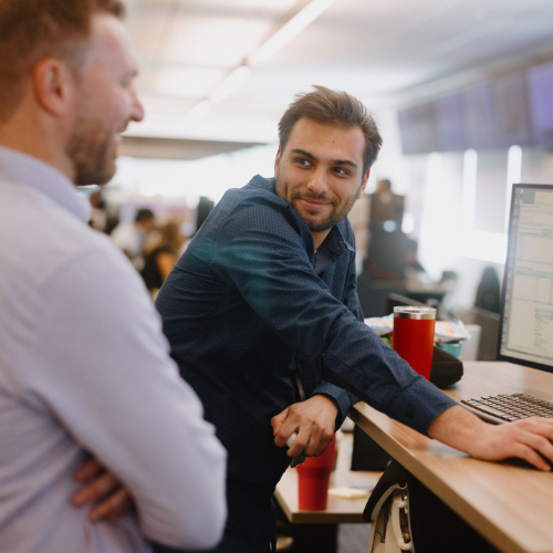 Colleagues working at a standing desk station.