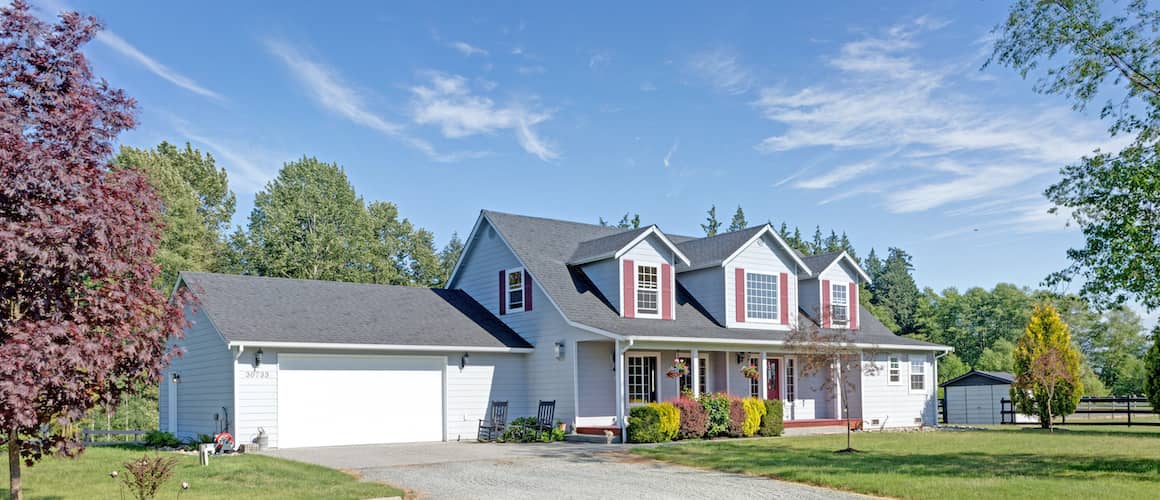 A house with distinctive red shutters, presenting a quaint residential setting.