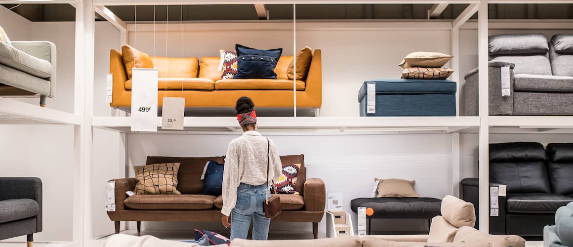 African American female customer choosing furniture.