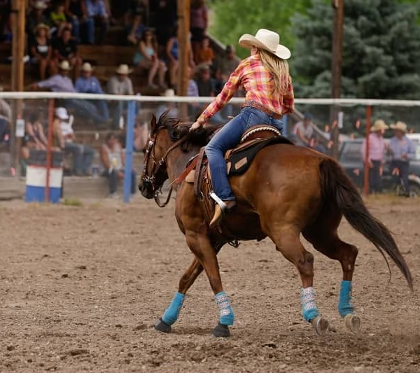 Woman on horseback during a barrel racing event in Montana. 