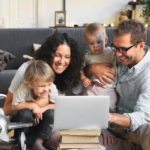 A family happily looking at home improvements online, exploring renovation options or planning upgrades.