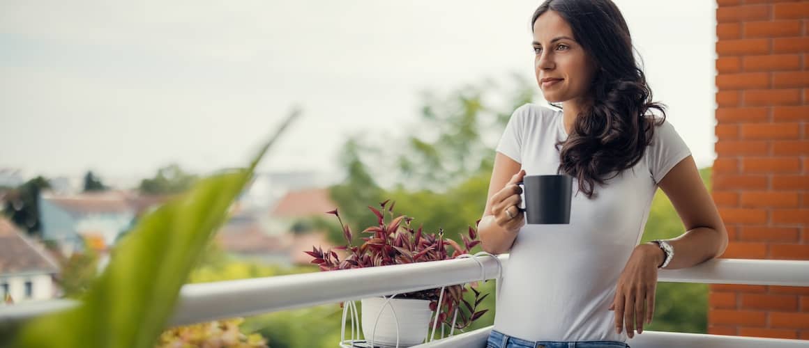 Woman Standing On Her Balcony