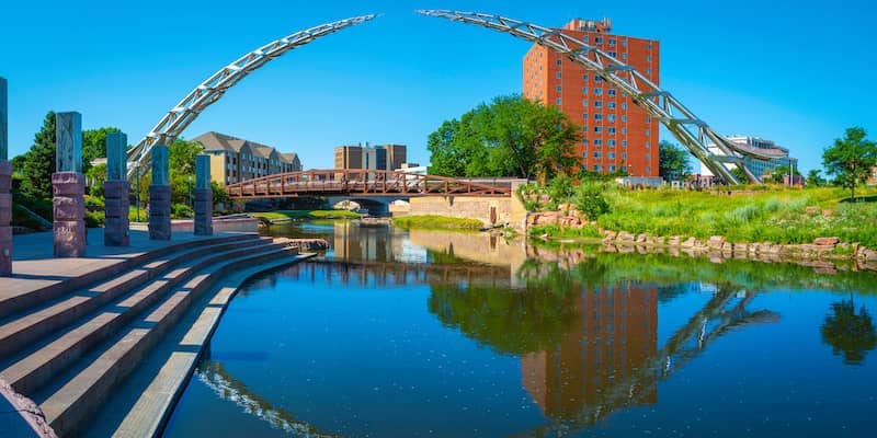 Sioux River running through a public park under a metal arch in South Dakota.