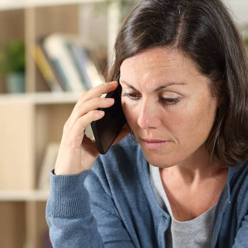 A women likely worried possibly after hearing some news on the phone.