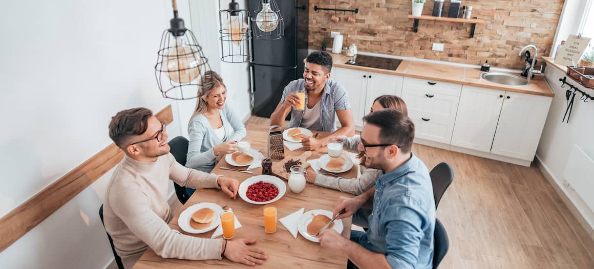 Roommates having breakfast together, indicating shared living arrangements.