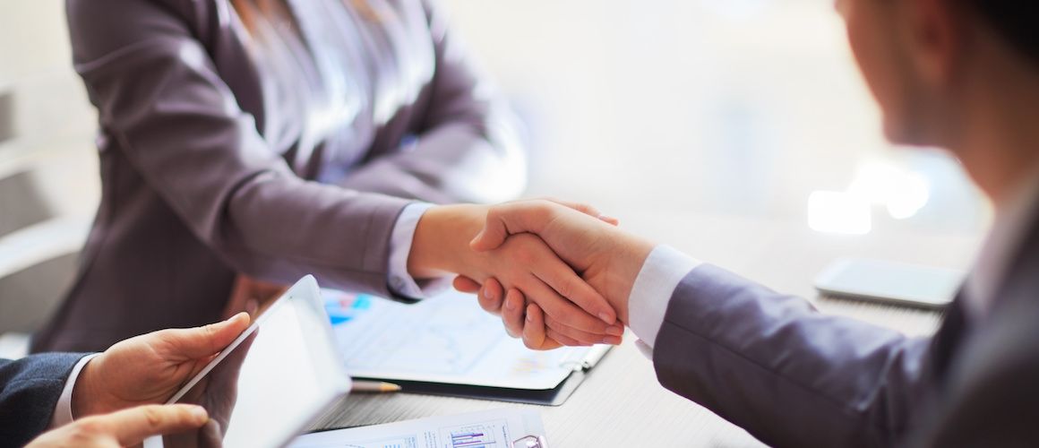 Image illustrating a business handshake, potentially representing a financial agreement or collaboration.