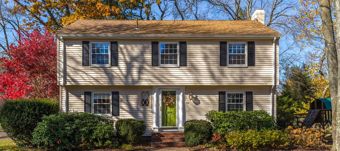 Tan, two-story house in autumn.