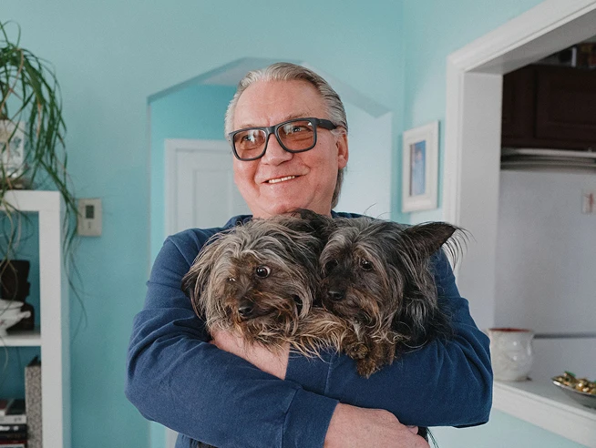 Man holding with dogs
