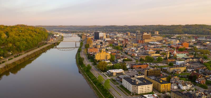 RHB Assets From IGX: Charleston, West Virginia, cityscape with a river and bridge.