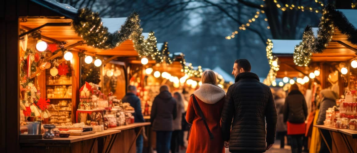 Couple strolling through holiday fair in the evening.