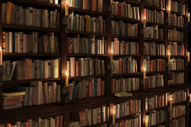 Two-storied bookshelves with candles.