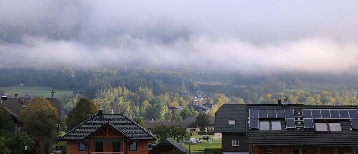 Foggy valley with solar-powered homes.