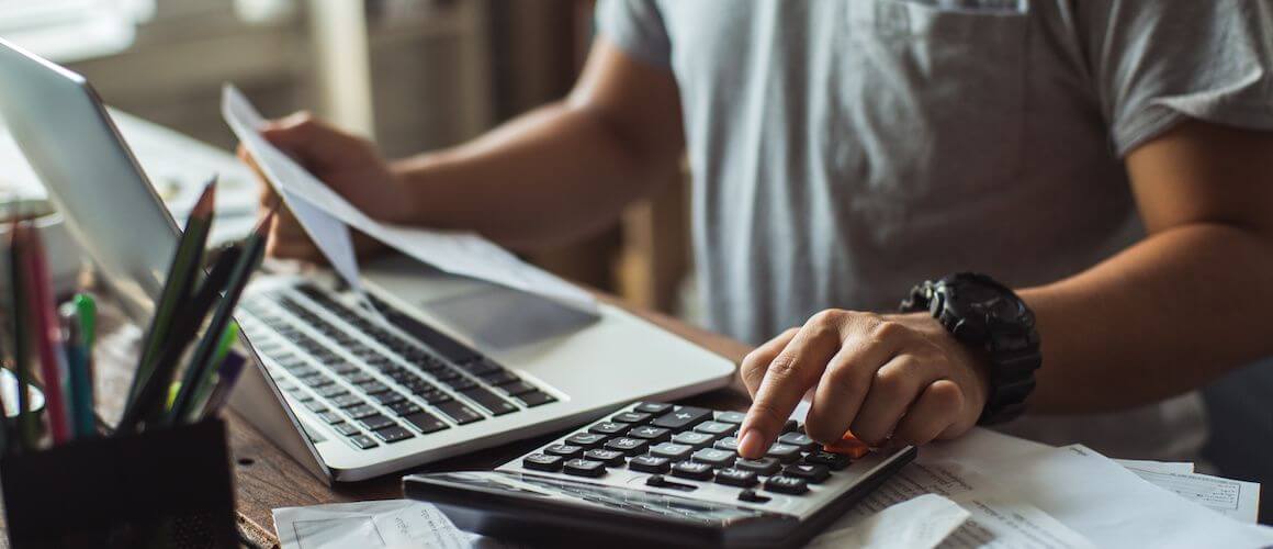 Stock-Man-Using-Calculator-Desk.jpg