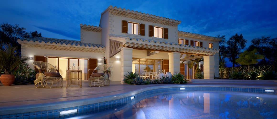 Large Mediterranean Villa with a pool at night.