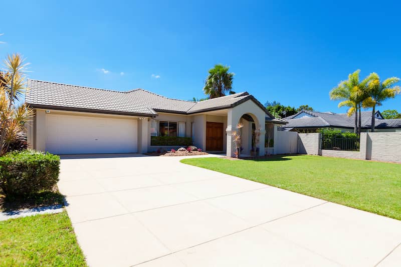 House with large driveway and walkway up to front door.