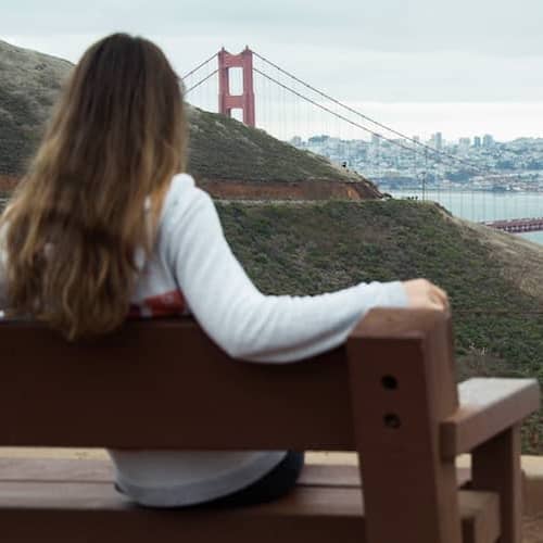Woman looking at the San Francisco bridge.