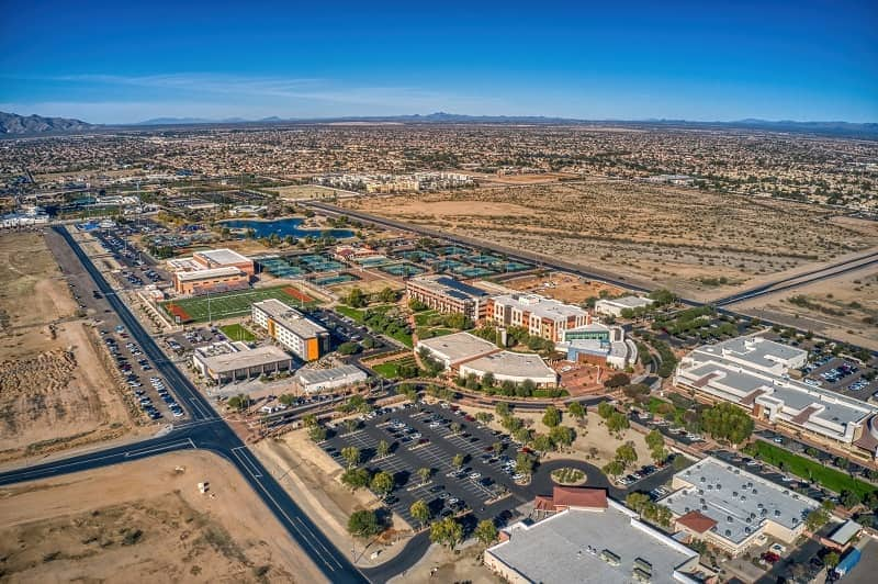 Aerial view of Surprise, Arizona in the desert with mountains behind.