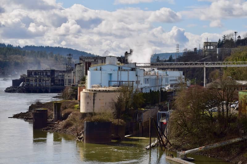 RHB Assets From IGX: Willamette Falls, Oregon on a sunny day with trees and water.