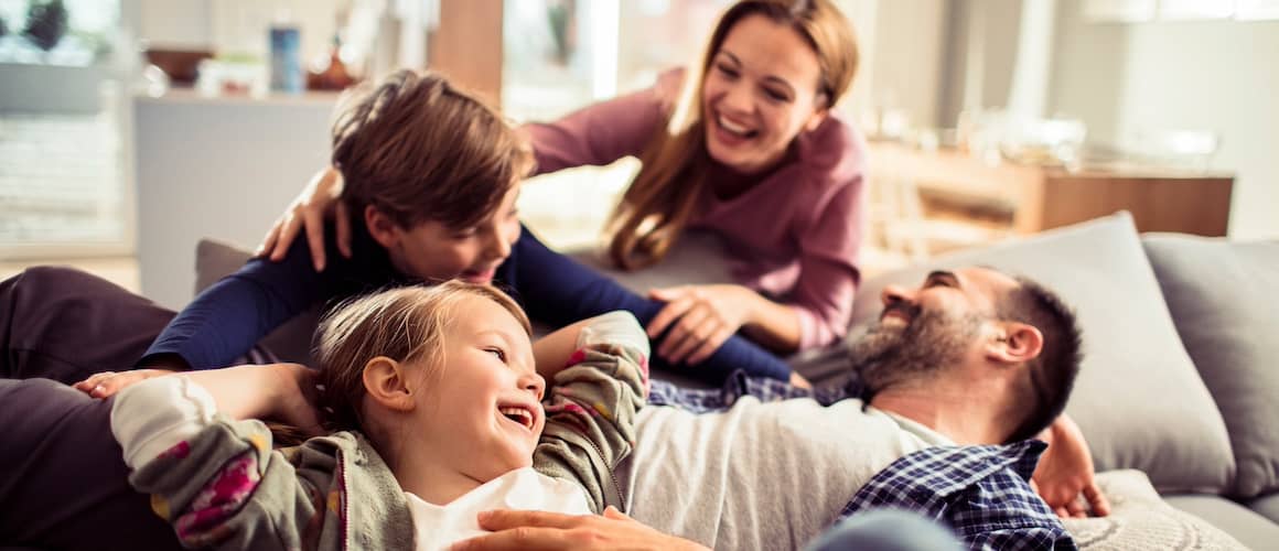 A happy family on a couch together.