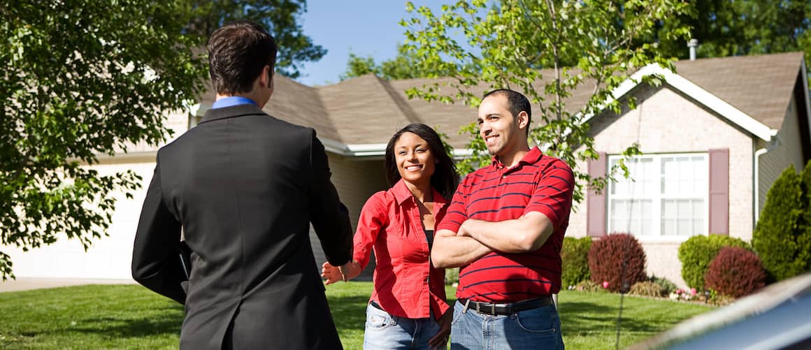 Couple meets with real estate agent.