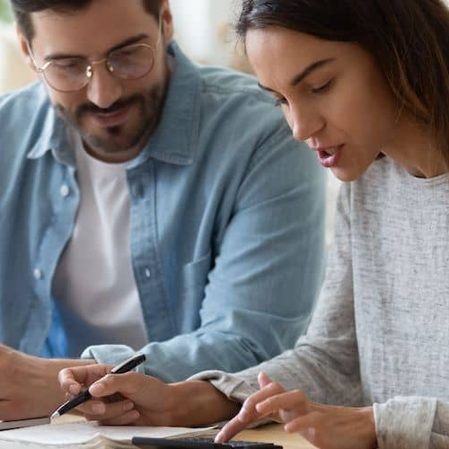 Image of couple filing taxes together.