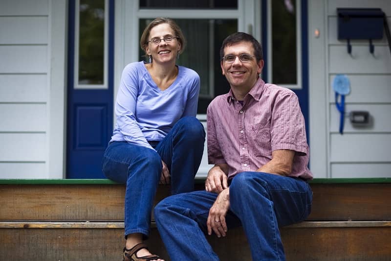 Front Porch Forum founders Michael and Valerie Wood-Lewis, smiling on their porch.