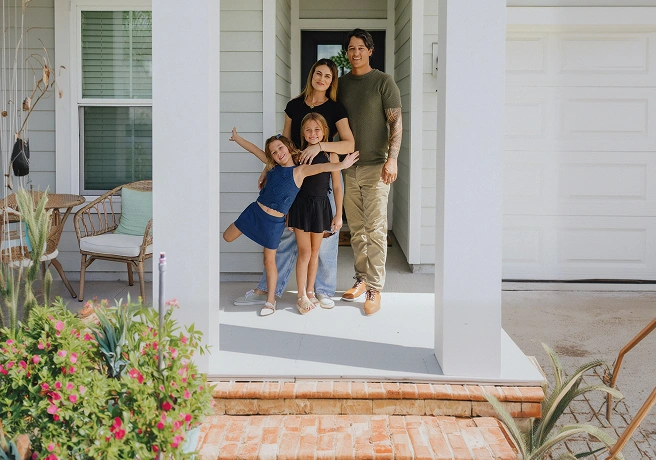 Family standing together in the doorway of a home.