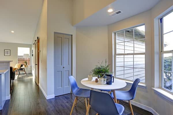 Breakfast nook with small table and windows.