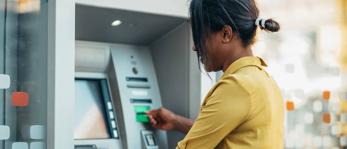 Woman getting money from ATM.