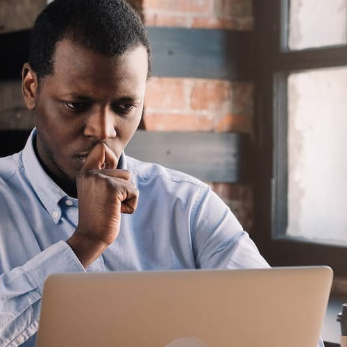 A person in thought, possibly contemplating mortgage or financial decisions.