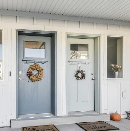 The front porch of a duplex with two doors, illustrating a multi-unit residential property.