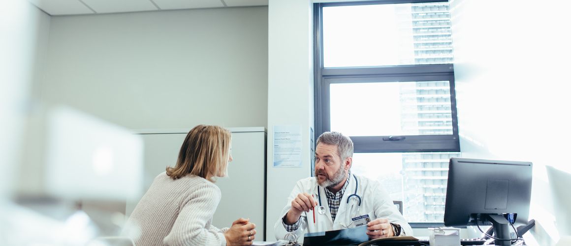 Image of doctor going over diagnosis with patient.