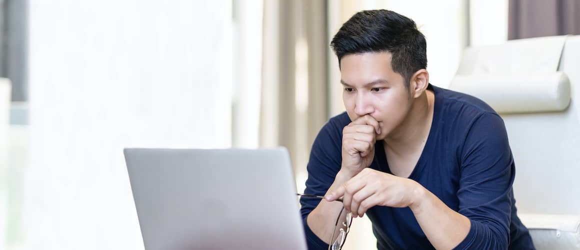 Stressed man holding glasses, indicating potential stress related to homeownership or finances.